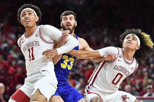 Arkansas forward Jalen Graham (11) and guard Anthony Black (0) block out Wednesday, Nov. 16, 2022, against South Dakota State forward Broden Lien (33) during the first half of play in Bud Walton Arena in Fayetteville.