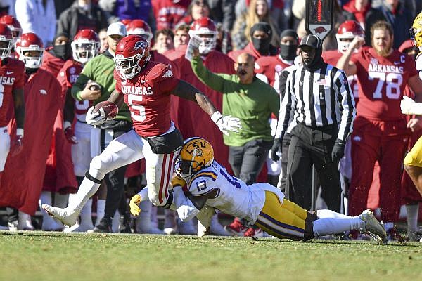 Arkansas running back Raheim Sanders (5) attempts to break a tackle by LSU safety Joe Foucha (13), Saturday, Nov. 12, 2022, during the fourth quarter of the Tigers’ 13-10 win over the Razorbacks at Donald W. Reynolds Razorback Stadium in Fayetteville. Visit nwaonline.com/221113Daily/ for today's photo gallery....(NWA Democrat-Gazette/Hank Layton)