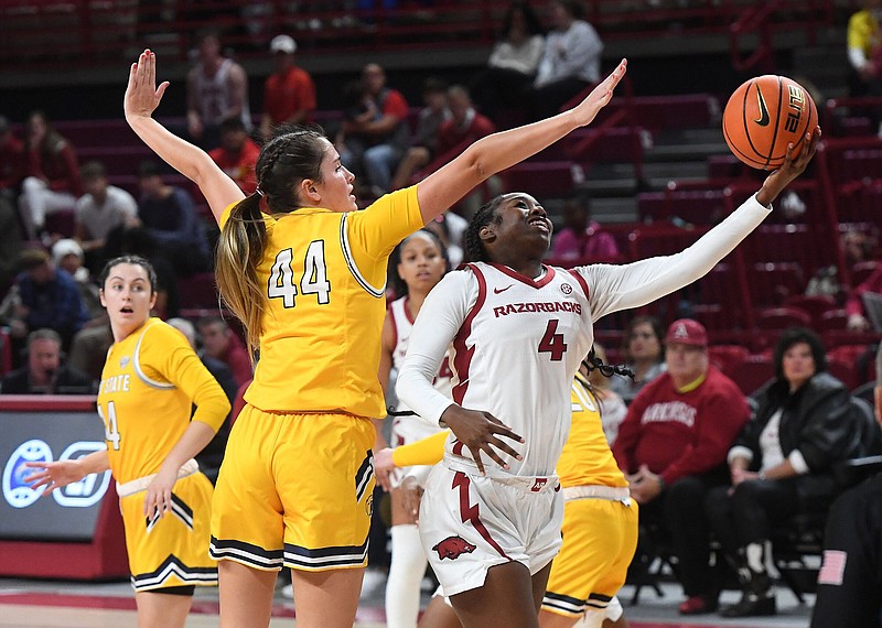 Arkansas’ Erynn Barnum (4) puts up a shot in front of Kent State’s Lindsey Thall on Thursday during the Razorbacks’ 80-59 victory at Walton Arena in Fayetteville. Barnum finished with 20 points and six rebounds.
(NWA Democrat-Gazette/J.T. Wampler)