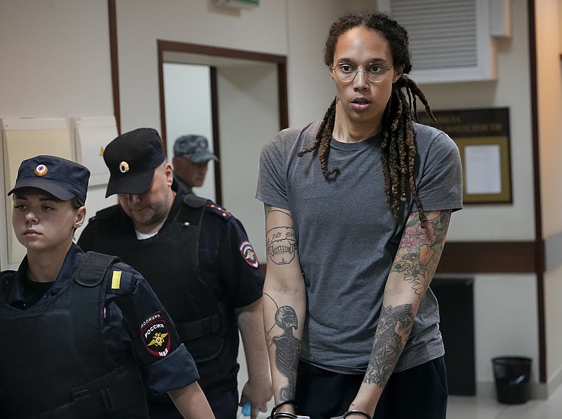 FILE - WNBA star and two-time Olympic gold medalist Brittney Griner is escorted from a courtroom after a hearing in Khimki just outside Moscow, Russia, on Aug. 4, 2022. (AP Photo/Alexander Zemlianichenko, File)