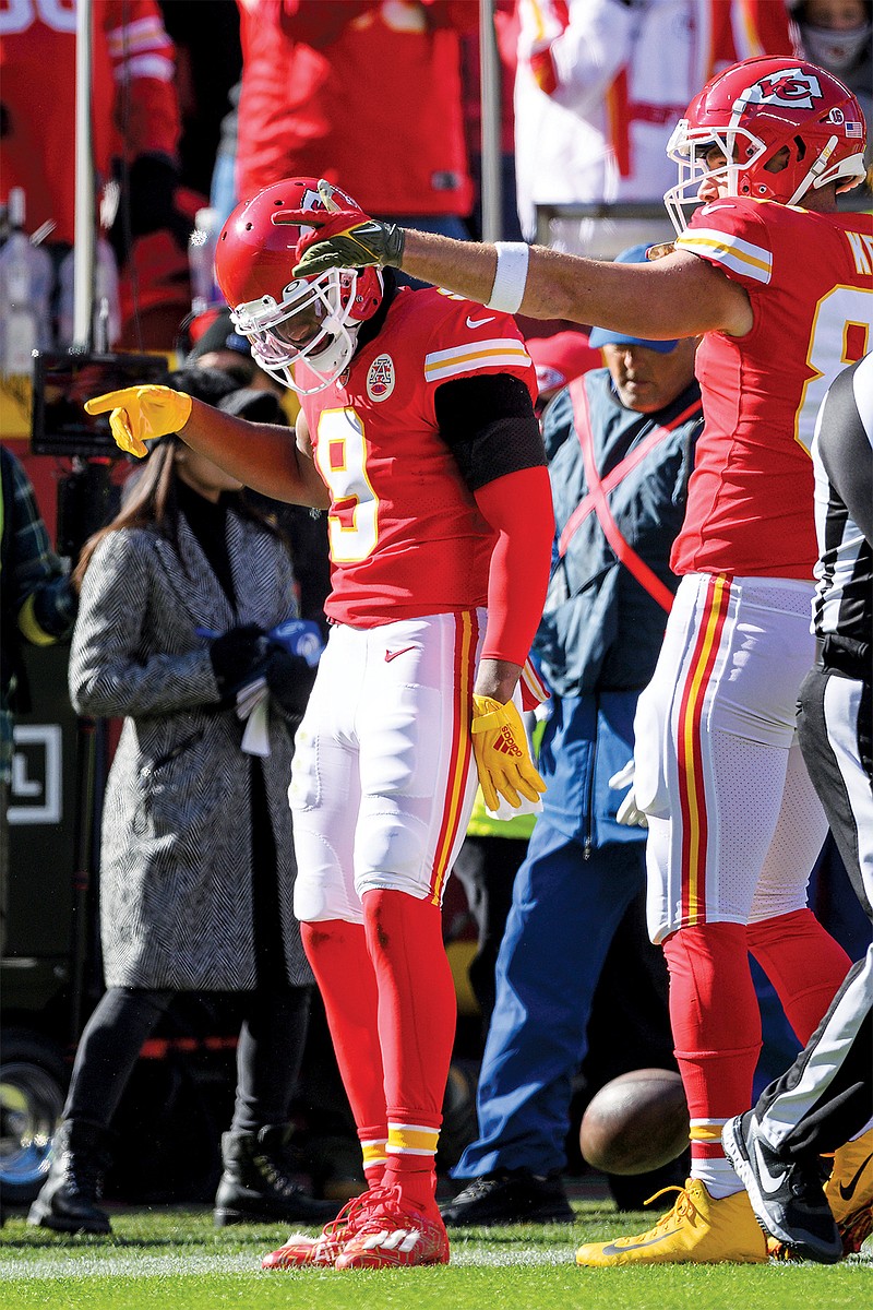 Chiefs wide receiver JuJu Smith-Schuster is joined by tight end Travis Kelce in celebrating a first down during Sunday’s game against the Jaguars at Arrowhead Stadium in Kansas City. (Associated Press)