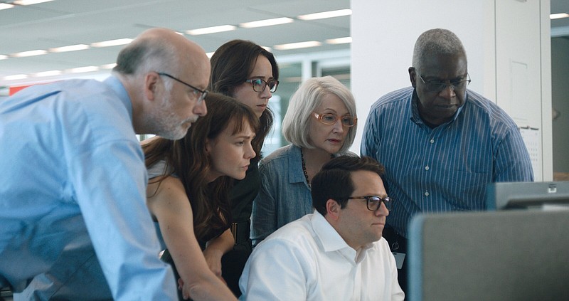 The New York Times team of (from left) editor Matt Purdy (Frank Wood), investigative reporter Megan Twohey (Carey Mulligan), workplace reporter Jodi Kantor (Zoe Kazan), editor Rebecca Corbett (Patricia Clarkson), senior editor Rory Tolan (Davram Stiefler) and executive editor Dean Baquet (Andre Braugher) check the copy on one of the stories that eventually brought down a sexual predator in Maria Schrader’s “She Said.”