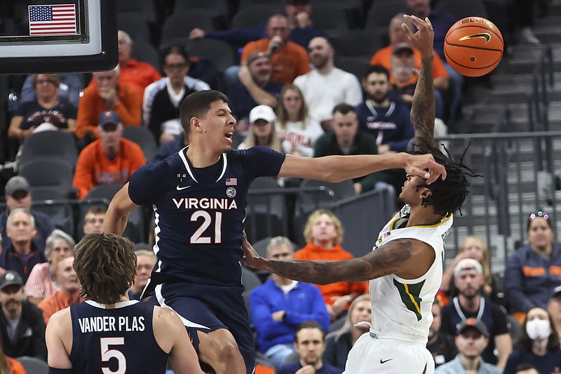 Virginia forward Kadin Shedrick (21) blocks a shot by Baylor forward Jalen Bridges on Friday during the No. 16 Cavaliers’ 86-79 victory over the No. 5 Bears in Las Vegas.
(AP/Chase Stevens)