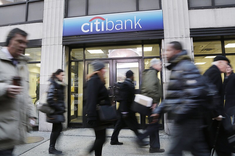 People walk past a New York Citibank branch office in 2015.
(AP/Mark Lennihan)