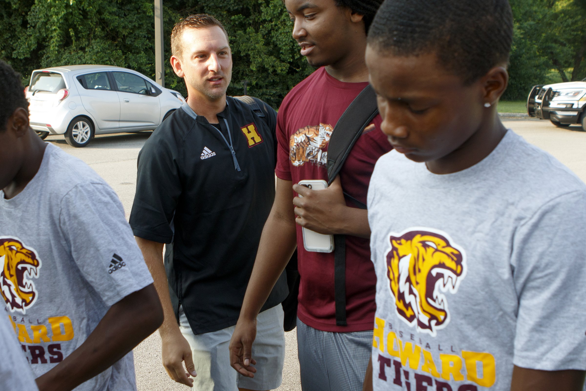 Staff photo by C.B. Schmelter / .Howard baseball coach Jon Johnson, second from left, talks with some of his players before getting on a charter bus to head to Atlanta at Howard School on Monday, Aug. 13, 2018 in Chattanooga, Tenn.