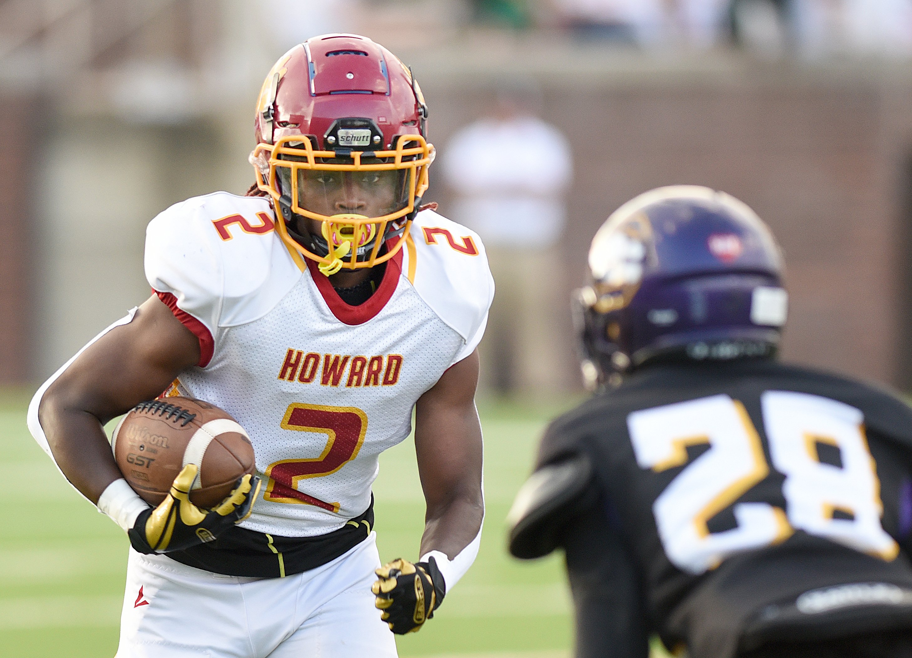 Staff photo by Matt Hamilton / Chattanooga Central (28) Copr'Darrius Jefferson defends as Howard (2) Ja'Caron Sanders carries the ball on Saturday, August 13, 2022 at Finley Stadium.