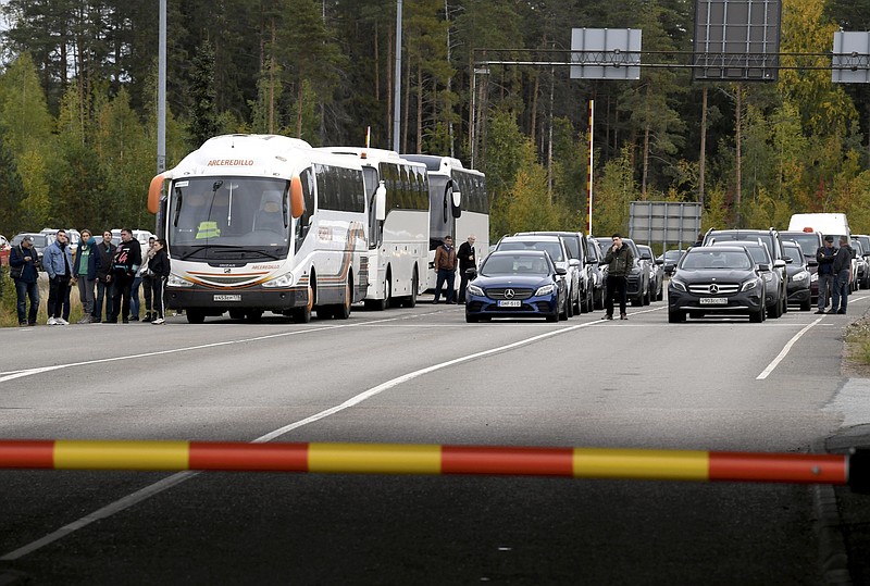 FILE - People traveling from Russia in cars and coaches queue to cross the border to Finland at the Vaalimaa border check point in Virolahti, Finland, Sunday, Sept. 25, 2022. (Jussi Nukari./Lehtikuva via AP, File)