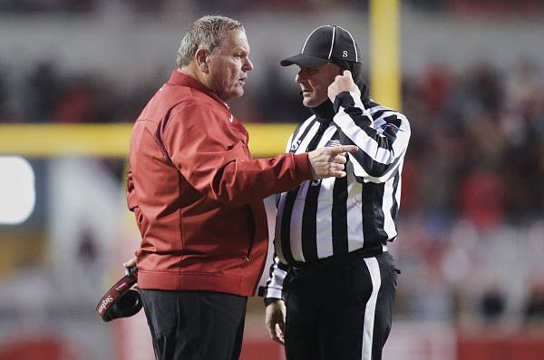 Arkansas head coach Sam Pittman talks to an official, Saturday, November 19, 2022 during the first quarter of a football game at Donald W. Reynolds Razorback Stadium in Fayetteville. Visit nwaonline.com/221119Daily/ for today's photo gallery.......(NWA Democrat-Gazette/Charlie Kaijo)