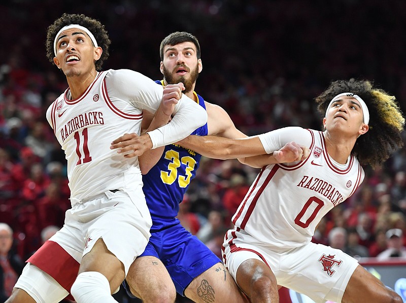 Arkansas forward Jalen Graham (11) and guard Anthony Black (0) block out Wednesday, Nov. 16, 2022, against South Dakota State forward Broden Lien (33) during the first half of play in Bud Walton Arena in Fayetteville. Visit nwaonline.com/221117Daily/ for today's photo gallery. .(NWA Democrat-Gazette/Andy Shupe)