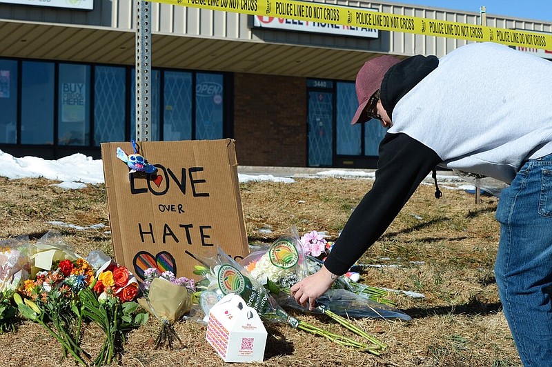 Elijah Newcomb of Colorado Springs lays flowers near a gay nightclub in Colorado Springs, Colo., Sunday, Nov. 20, 2022 where a shooting occurred late Saturday night. (AP/Geneva Heffernan)