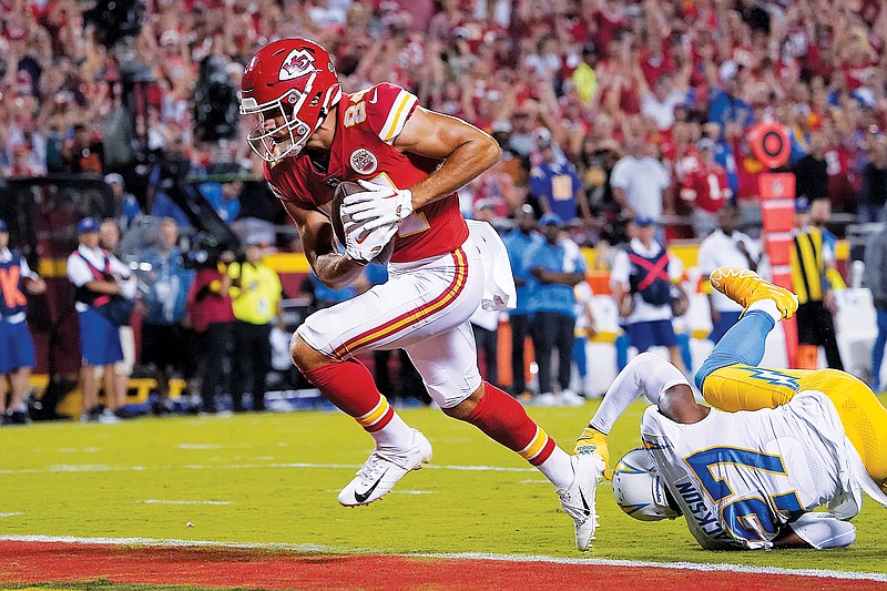 In this Sept. 15 file photo, Chiefs wide receiver Justin Watson avoids the tackle attempt of Chargers cornerback J.C. Jackson to score a touchdown in a game at Arrowhead Stadium in Kansas City. (Associated Press)