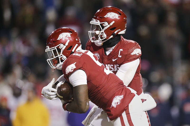 Arkansas quarterback KJ Jefferson (1) hands the ball off to running back Raheim Sanders (5), Saturday, November 19, 2022 during the second quarter of a football game at Donald W. Reynolds Razorback Stadium in Fayetteville. Visit nwaonline.com/221119Daily/ for today's photo gallery...(NWA Democrat-Gazette/Charlie Kaijo)