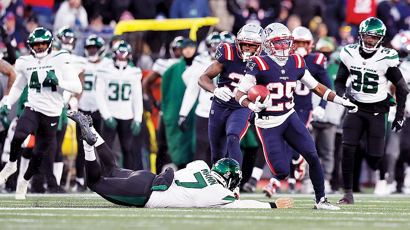 Marcus Jones of the Patriots runs past Jets punter Braden Mann on his return for a touchdown during the final minute of Sunday afternoon’s game in Foxborough, Mass. (Associated Press)