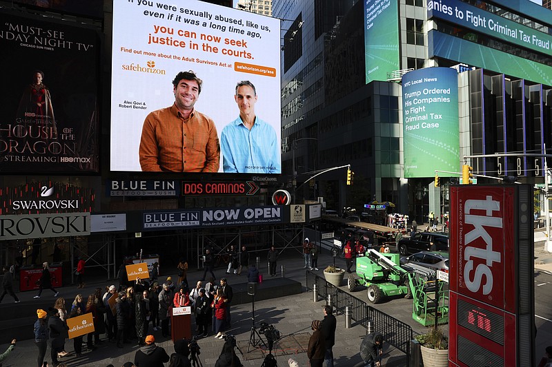 A Safe Horizon PSA about the Adult Survivors Act plays in Times Square during a press conference on the new law, Friday, Nov. 18, 2022, in New York. (AP Photo/Julia Nikhinson)