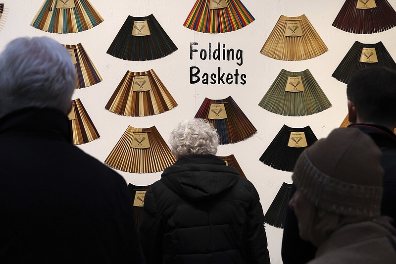 People shop for baskets made out of chopsticks in Bryant Park’s Winter Village in New York earlier this month.
(AP/Julia Nikhinson)