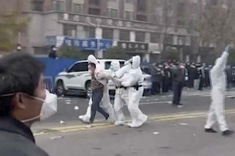Police in protective clothing were seen taking away a person during protest at a factory compound operated by Foxconn Technology Group in Zhengzhou in central China’s Henan province. Employees at the world’s biggest Apple iPhone factory were beaten and detained in protests over pay amid anti-virus controls, according to witnesses and videos on social media Wednesday.
(AP)