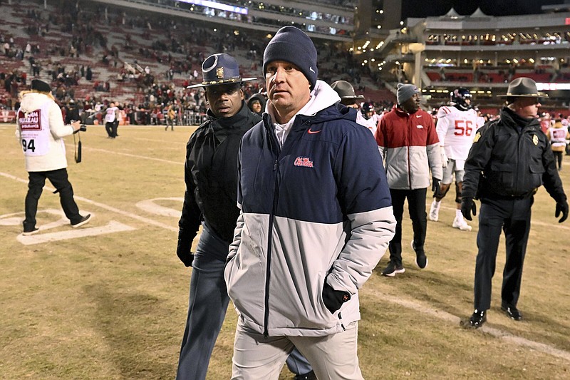 Mississippi coach Lane Kiffin walks back to the locker room after his loss to Arkansas during an NCAA college football game Saturday, Nov. 19, 2022, in Fayetteville, Ark. (AP Photo/Michael Woods)