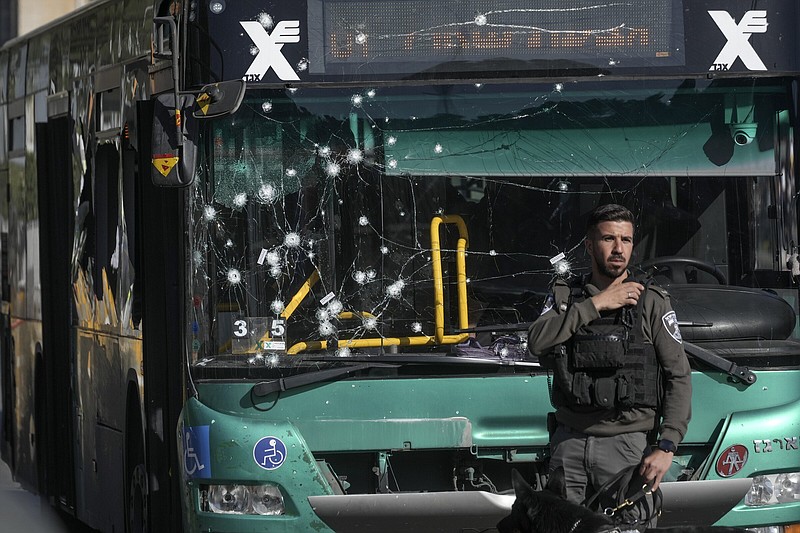 Israeli police inspect the scene of an explosion at a bus stop Wednesday in Jerusalem.
(AP/Mahmoud Illean)