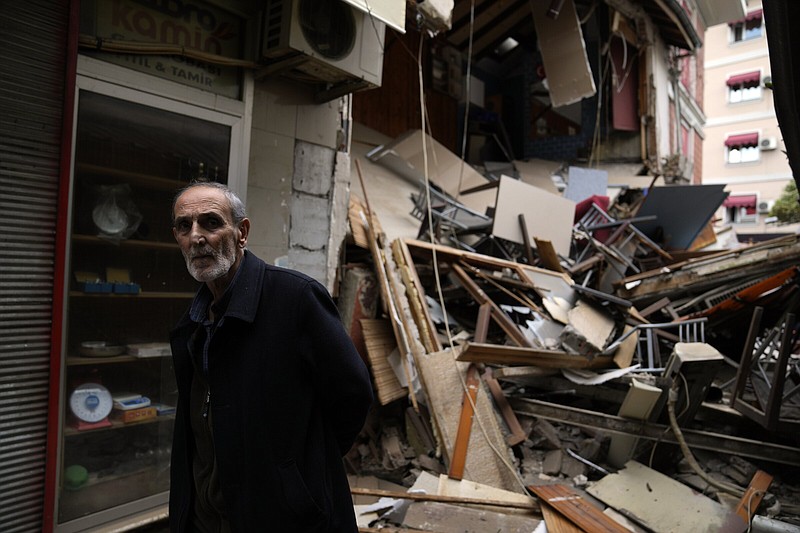 A man walks past damaged shops Wednesday in Duzce, Turkey, after a magnitude 5.9 earthquake hit a town in northwest Turkey.
(AP/Khalil Hamra)