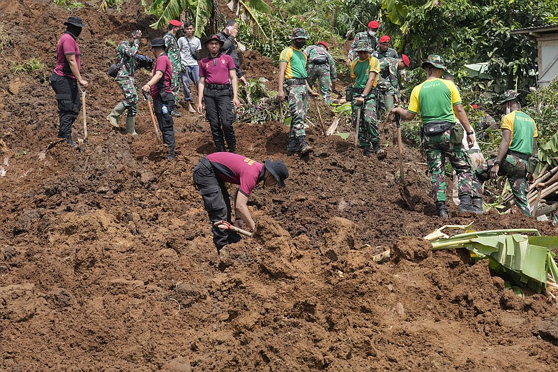 Rescuers search for victims of an earthquake-triggered landslide in Cianjur, West Java, Indonesia, Wednesday, Nov. 23, 2022. More rescuers and volunteers were deployed Wednesday in devastated areas on Indonesia's main island of Java to search for the dead and missing from an earthquake that killed hundreds of people. (AP Photo/Tatan Syuflana)