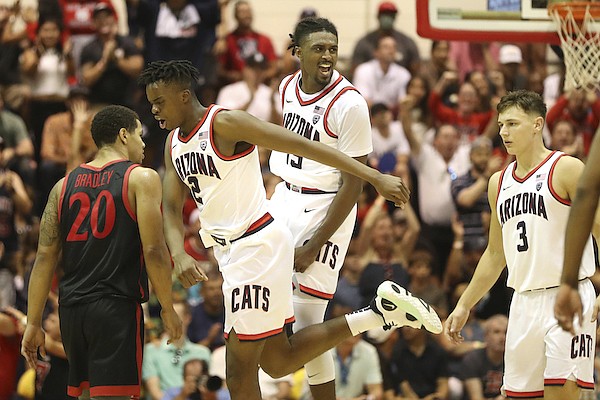 Arizona guard Cedric Henderson Jr. and guard Adama Bal react after Henderson Jr. made a three pointer against San Diego State during the second half of an NCAA college basketball game, Tuesday, Nov. 22, 2022, in Lahaina, Hawaii. (AP Photo/Marco Garcia)