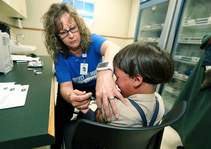 A registered nurse and immunization outreach coordinator with the Knox County Health Department, administers a vaccination to a kid at the facility in Mount Vernon, Ohio, Friday May 17, 2019. In a report issued Wednesday, Nov. 23, 2022, the World Health Organization and the U.S. Centers for Disease Control and Prevention say measles immunization has dropped significantly since the coronavirus pandemic began, resulting in a record high of nearly 40 million children missing a vaccine dose last year. (AP Photo/Paul Vernon, File)