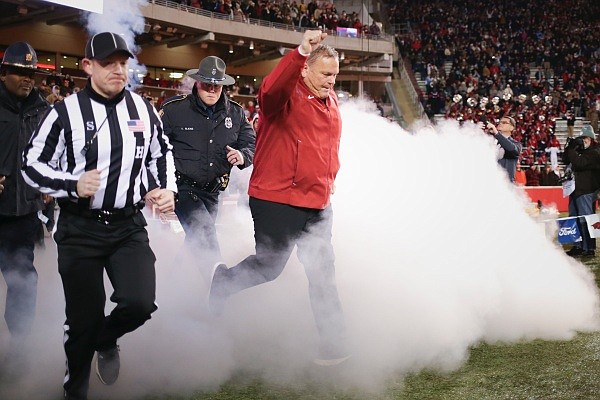 Arkansas coach Sam Pittman runs out onto the field on Saturday, November 19, 2022, before the start of a football game at Donald W. Reynolds Razorback Stadium in Fayetteville.