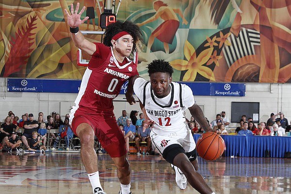 Arkansas guard Anthony Black pressures San Diego State’s Darrion Trammell during the Razorbacks’ 78-74 overtime victory Wednesday
night at the Maui Invitational in Lahaina, Hawaii. Black scored 15 points in the victory, which gave the Razorbacks a third-place
finish in the tournament.
(Photo courtesy Brian Spurlock Kemper/Lesnik)