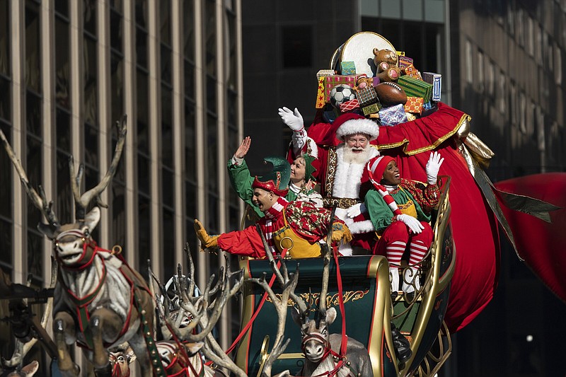 Santa Claus waves from atop a float along 6th Avenue during the Macy’s Thanksgiving Day Parade, Thursday in New York.
(AP/Jeenah Moon)