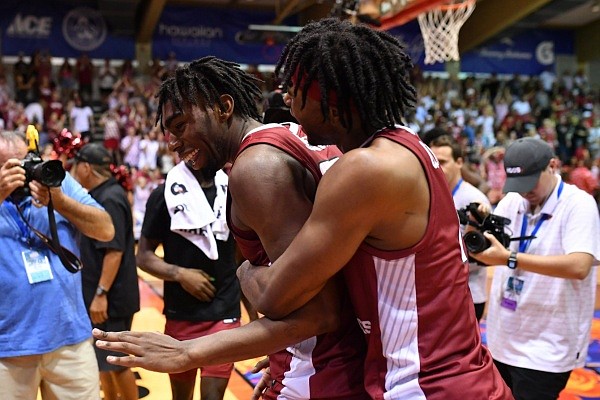 Arkansas forward Kamani Johnson (left) and guard Ricky Council celebrate following the Razorbacks' 78-74 overtime victory over San Diego State on Wednesday, Nov. 23, 2022, at the Maui Invitational in Lahaina, Hawaii.