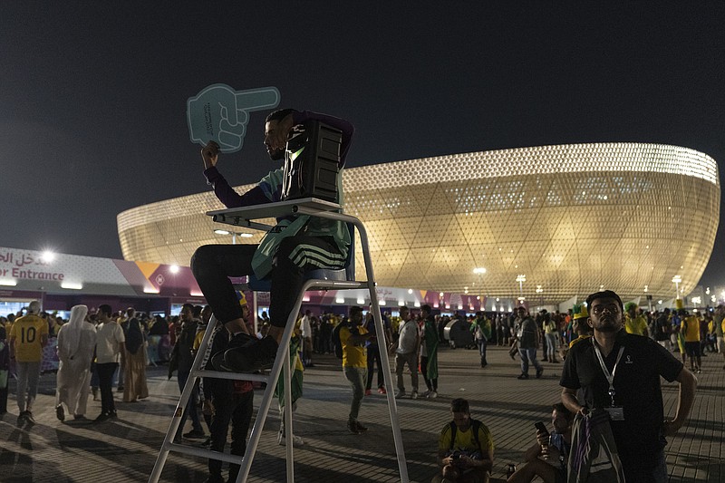 Osama, 21 years-old, from Palestine works as a street marshal prior to the World Cup group G soccer match between Brazil and Serbia, at the Lusail Stadium in Lusail, Qatar, Thursday, Nov. 24, 2022. (AP Photo/Moises Castillo)