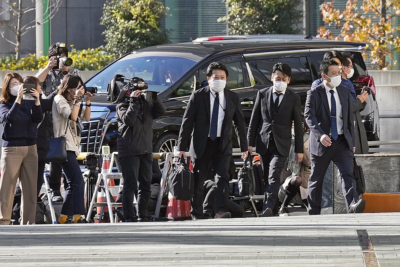 Investigators enter the headquarters of major advertising company Dentsu in Tokyo Friday, Nov. 25, 2022. (Kyodo News via AP)