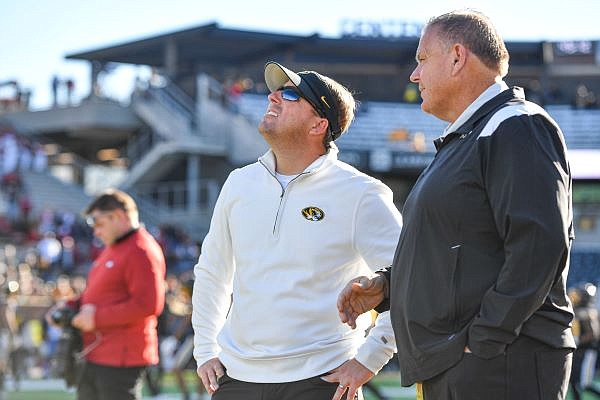 Arkansas head coach Sam Pittman (right) speaks with Missouri head coach Eliah Drinkwitz, Friday, Nov. 25, 2022, before the first quarter at Faurot Field in Columbia, Mo. Visit nwaonline.com/221126Daily/ for today's photo gallery....(NWA Democrat-Gazette/Hank Layton)