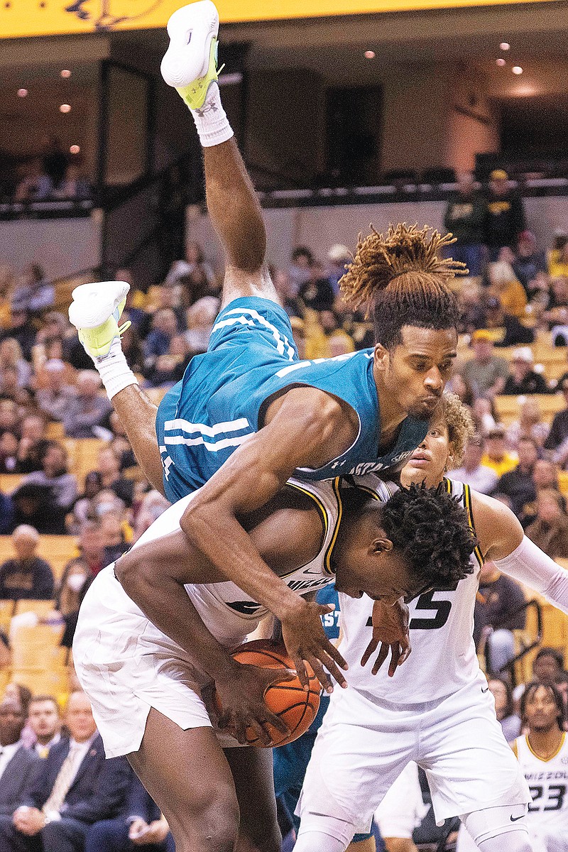 Coastal Carolina's Jomaru Brown fouls Missouri's Kobe Brown during the second half of Wednesday night's game at Mizzou Arena in Columbia. (Associated Press)