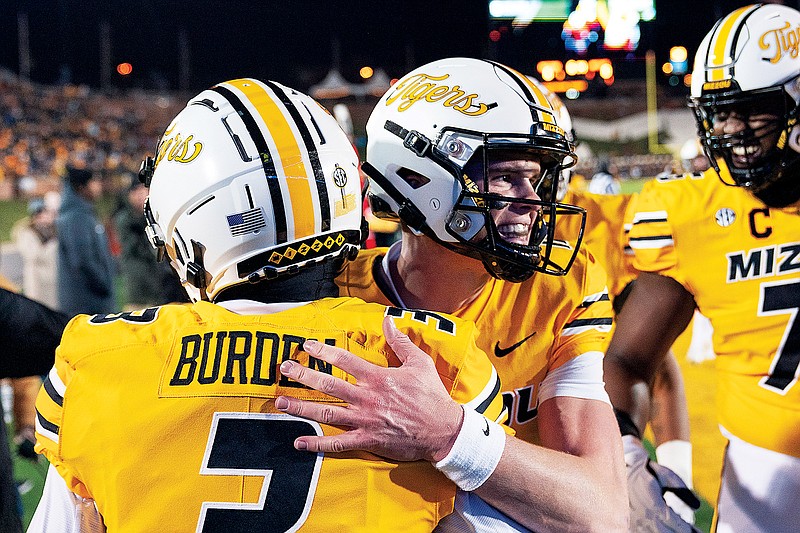 Missouri quarterback Brady Cook hugs Luther Burden after Burden scored a touchdown during the first quarter of last Saturday night’s win against New Mexico State at Faurot Field in Columbia. (Associated Press)