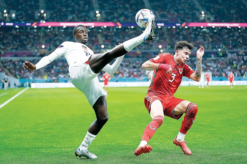 Tim Weah of the United States clears the ball in front of Wales' Neco Williams during a World Cup Group B match Monday in Doha, Qatar. (Associated Press)