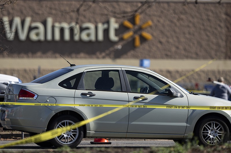 Crime scene tape surrounds a car at the scene of a mass shooting at a Walmart, Wednesday, Nov. 23, 2022, in Chesapeake, Va.  A Walmart manager opened fire on fellow employees in the break room of the Virginia store, killing several people in the countryâ€™s second high-profile mass shooting in four days, police and witnesses said Wednesday.  (AP Photo/Alex Brandon)