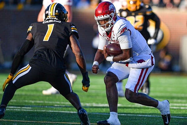 Arkansas quarterback KJ Jefferson (1) carries the ball as Missouri defensive back Jaylon Carlies (1) prepares to tackle, Friday, Nov. 25, 2022, during the second quarter at Faurot Field in Columbia, Mo. Visit nwaonline.com/221126Daily/ for the photo gallery.