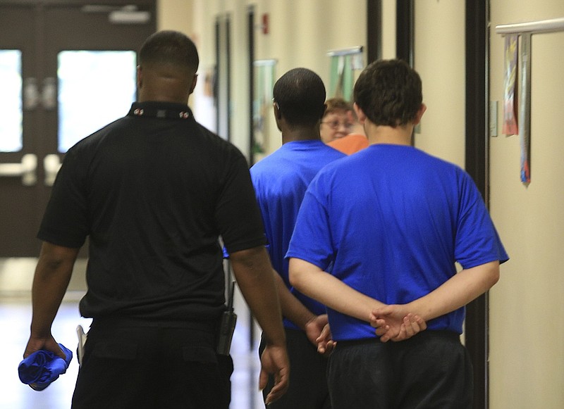 Boys are escorted by staff in the school at the Arkansas Juvenile Assessment and Treatment Center near Alexander, the state's largest juvenile lockup, in this June 2014 file photo. (Arkansas Democrat-Gazette/Staton Breidenthal)