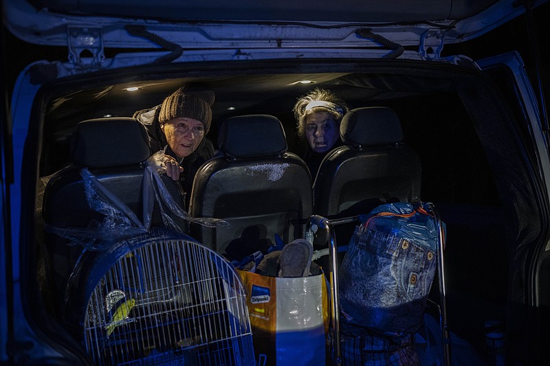 Elderly residents are evacuated by a local organization from the southern city of Kherson, Ukraine, Sunday, Nov. 27, 2022. Shelling by Russian forces struck several areas in eastern and southern Ukraine overnight as utility crews continued a scramble to restore power, water and heating following widespread strikes in recent weeks, officials said Sunday. (AP Photo/Bernat Armangue)