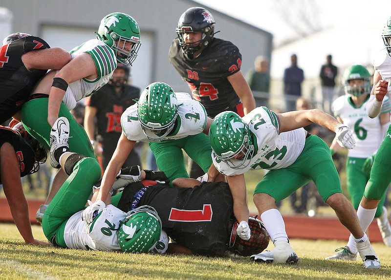 Jaxon Marshall (70), Alec Wieberg (2) and Doug Blaha (23) of Blair Oaks bring down Bowling Green running back Marcus Starks during Saturday’s Class 2 state semifinal game in Bowling Green. (Greg Jackson/News Tribune)