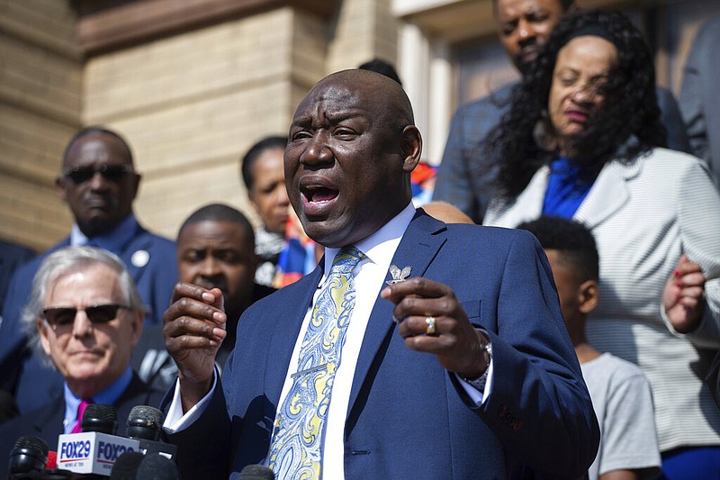 Attorney Benjamin Crump speaks during a news conference outside the Antioch Baptist Church in Buffalo, N.Y., in this May 19, 2022 file photo. Surrounding him are family members of victims of the May 14, 2022 Buffalo supermarket shooting. (AP/Joshua Bessex)