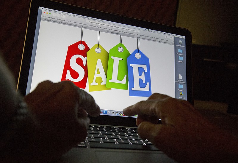 In this Dec. 12, 2016, photo, a person searches the internet for sales, in Miami. Days after flocking to stores on Black Friday, consumers are turning online for Cyber Monday to score more discounts on gifts and other items that have ballooned in price because of high inflation. Adobe Analytics, which tracks transactions for top online retailers, forecasts Cyber Monday will remain the year’s biggest online shopping day and rake in up to $11.6 billion in sales. (AP Photo/Wilfredo Lee)