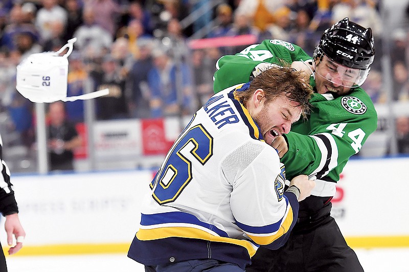 Nathan Walker of the Blues fights Joel Hanley of the Stars during Monday night’s game at Enterprise Center in St. Louis. (Associated Press)