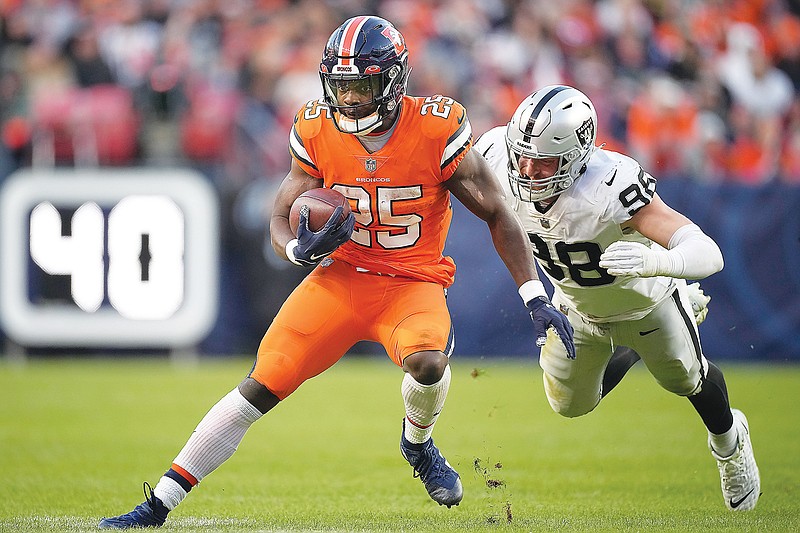 Melvin Gordon runs with the ball for the Broncos during a game earlier this month against the Raiders in Denver. (Associated Press)