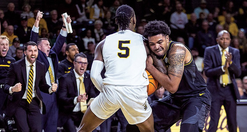 Missouri’s Ronnie DeGray III gets locked up with Wichita State’s Jaron Pierre Jr. during Tuesday night’s game in Wichita, Kan. (Associated Press)