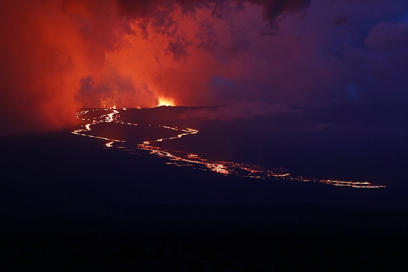 Lava flows down the mountain from the Mauna Loa eruption, Tuesday, Nov. 29, 2022, near Hilo, Hawaii. (AP/Marco Garcia)