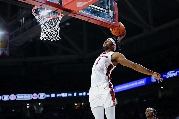 Arkansas guard Ricky Council IV (1) dunks, Monday, November 28, 2022 during the first half of a basketball game at Bud Walton Arena in Fayetteville. Visit nwaonline.com/221129Daily/ for the photo gallery.