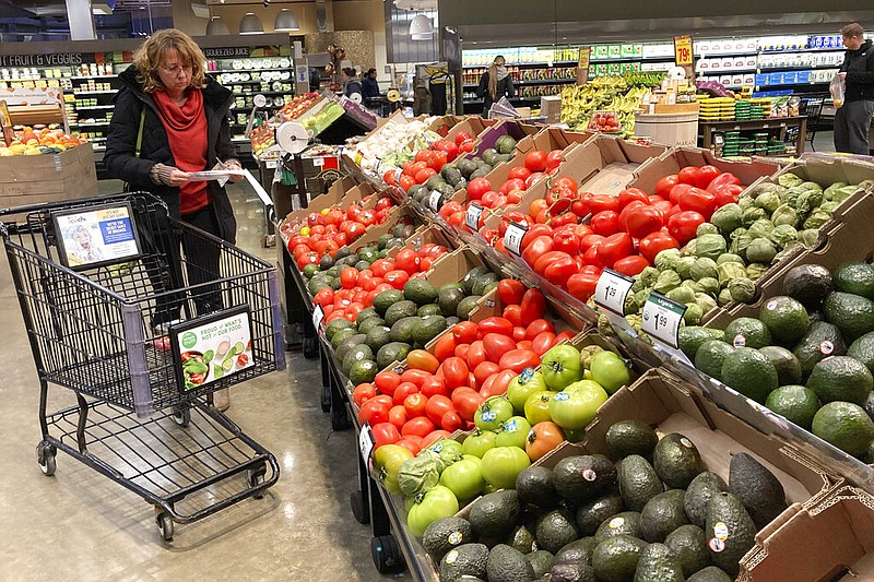 Shoppers pick out items at a grocery store in Glenview, Ill., Saturday, Nov. 19, 2022. Americans are bracing for a costly Thanksgiving this year, with double-digit percent increases in the price of turkey, potatoes, stuffing, canned pumpkin and other staples. (AP/Nam Y. Huh)