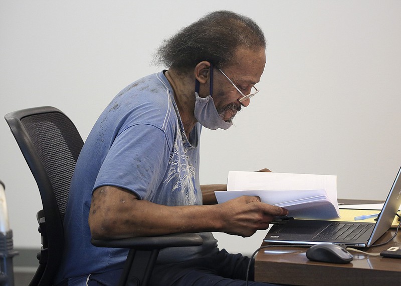 Kenyon Lowe Sr., chairman of the Metropolitan Housing Alliance Board of Commissioners, looks over papers on Aug. 25, 2021, before the start of a commission meeting in Little Rock.
(Arkansas Democrat-Gazette/Staton Breidenthal)